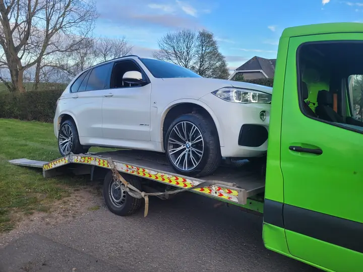 White BMW X5 on the bed